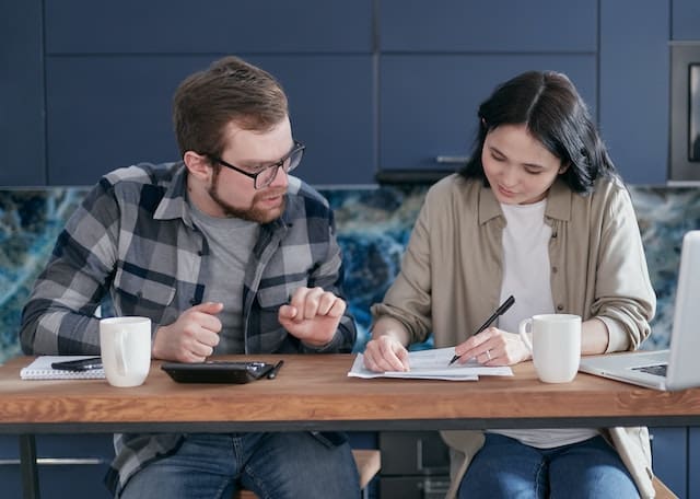 two young people looking over their finances to find tax savings